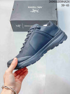 Side view of the low-top hiking shoe with lace-up closure and protective overlays