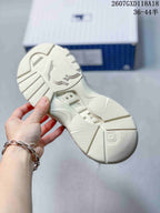 Underside of the sneaker showing a segmented white outsole with textured tread sections.