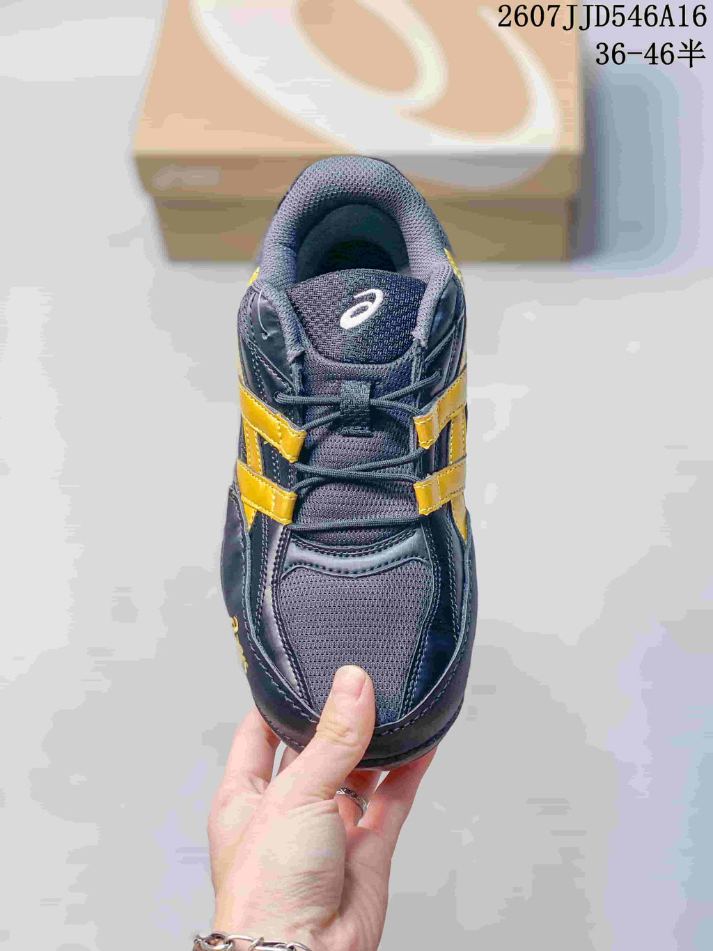 Top view of one ASICS Hypersync sneaker showing the mesh toe box, tongue, laces, and yellow side accents.