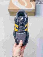 Top view of one ASICS Hypersync sneaker showing the mesh toe box, tongue, laces, and yellow side accents.