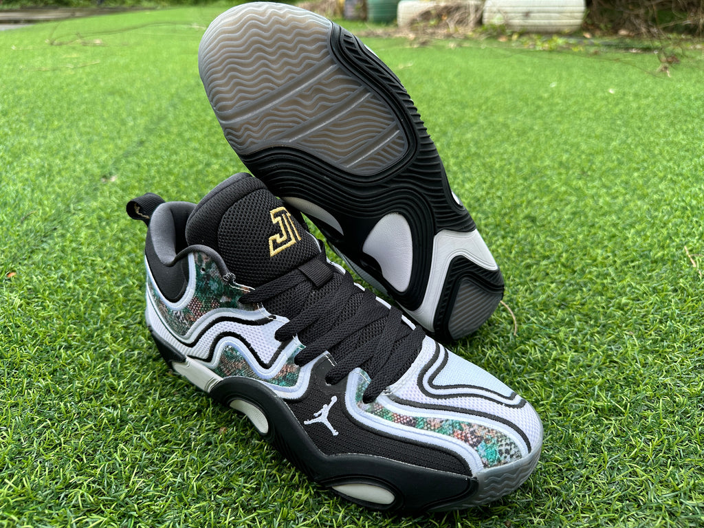 Jordan basketball shoe with sculpted black-and-white outsole shown beside the upper
