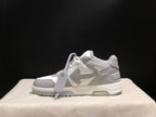 Side view of one sneaker highlighting the layered upper construction, attached hangtag, and outsole.