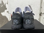Rear view of purple and black Nike Kobe basketball shoes with speckled soles and EYBL graphics.