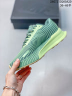 Side profile showing the patterned green upper, lime midsole, and rugged outsole.
