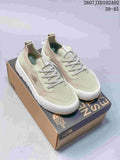 Three colorways of The North Face Dune sneakers shown from the side: gray and olive, light sage, and dark blue-gray.