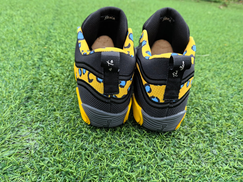 Rear view showing yellow patterned panels and gray soles