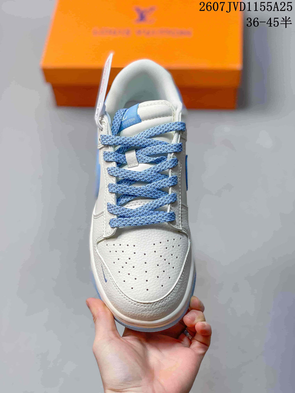 Top view showing the perforated white toe box and blue woven laces.