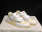 Pair of sneakers in a front three-quarter product view with white uppers, cream panels and red accents.