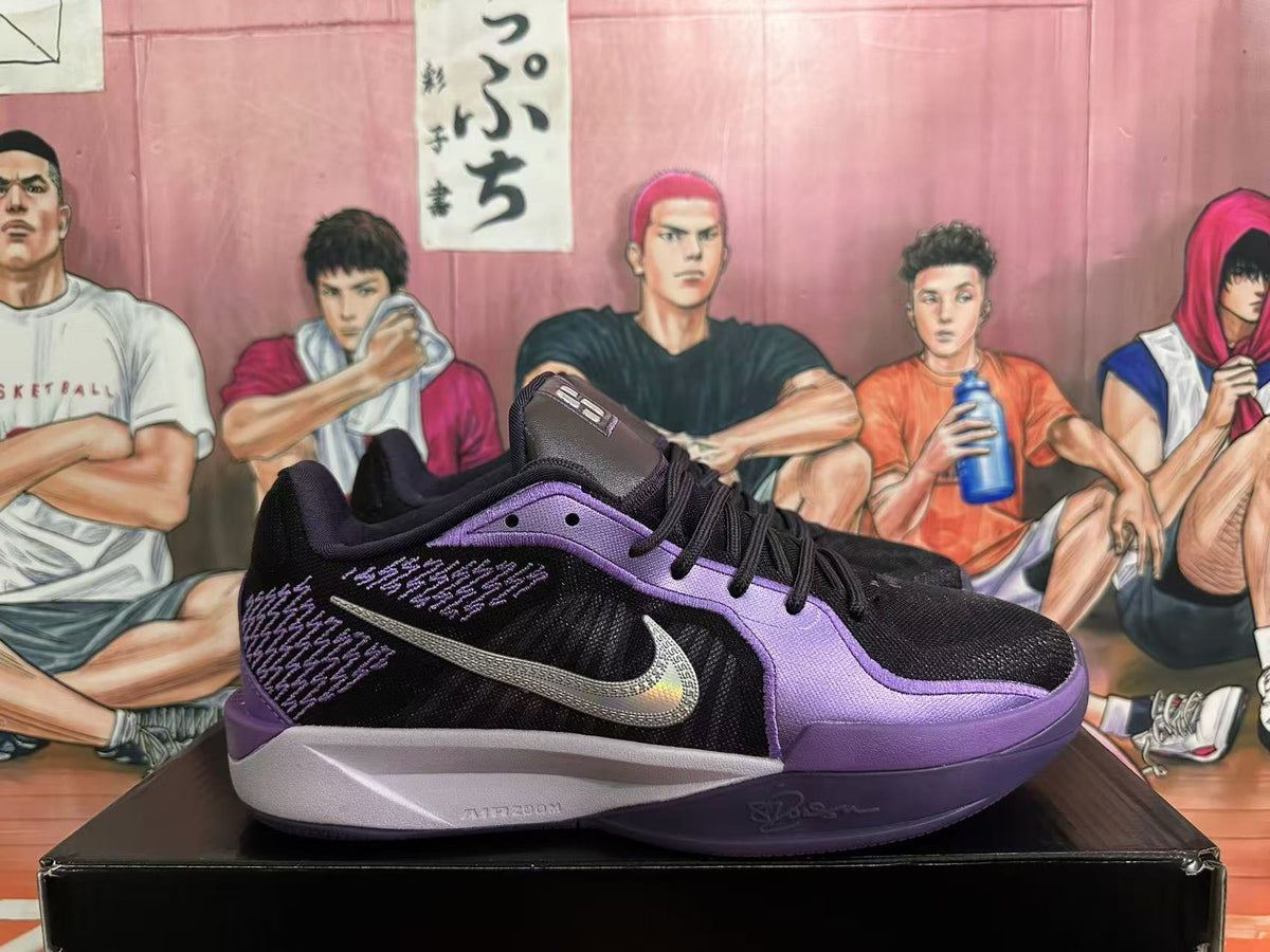 Side view of a black and purple Nike Sabrina basketball shoe with a silver-toned Swoosh.