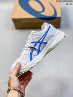 Side view of a white and blue ASICS Gel-Contend 4 sneaker showing the mesh panels, blue side branding, and layered midsole.