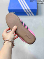 Close-up of the gum-colored outsole with adidas branding on a pink sneaker.