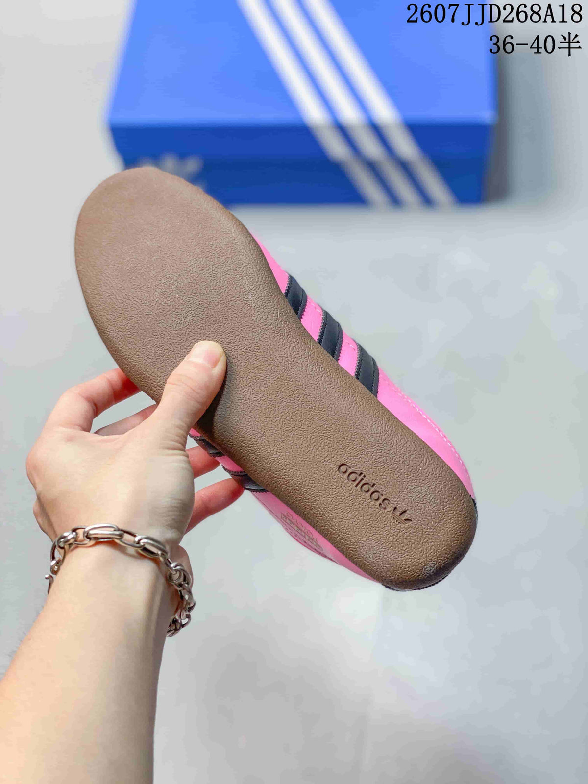 Close-up of the gum-colored outsole with adidas branding on a pink sneaker.