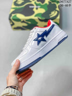 Side profile of a white BAPE Sta sneaker with a blue star-shaped side detail and blue outsole.