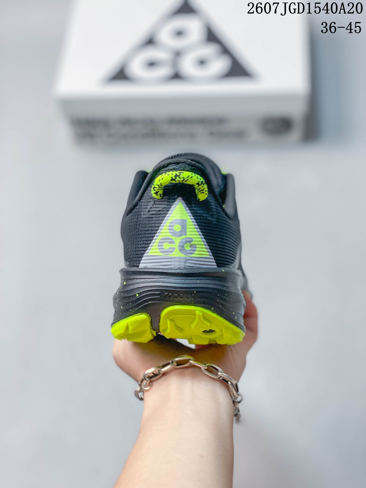 Rear view showing the ACG heel branding and neon green outsole accents.
