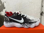 Side view of a patterned Nike shoe with a white Swoosh and red lining