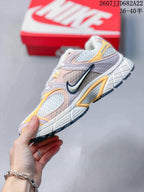 Side profile of the Nike V5 RNR sneaker showing the large side Swoosh, layered pink and yellow panels, and raised midsole; image text shows style code 2607JJD682A22 and size range 36–40.