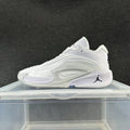 Side view of a white and gray Jordan basketball sneaker with a sculpted side panel and black Jumpman logo.