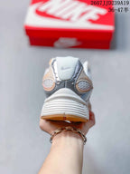 Rear view showing the padded heel, reflective-looking silver details, and gum-toned outsole sections.