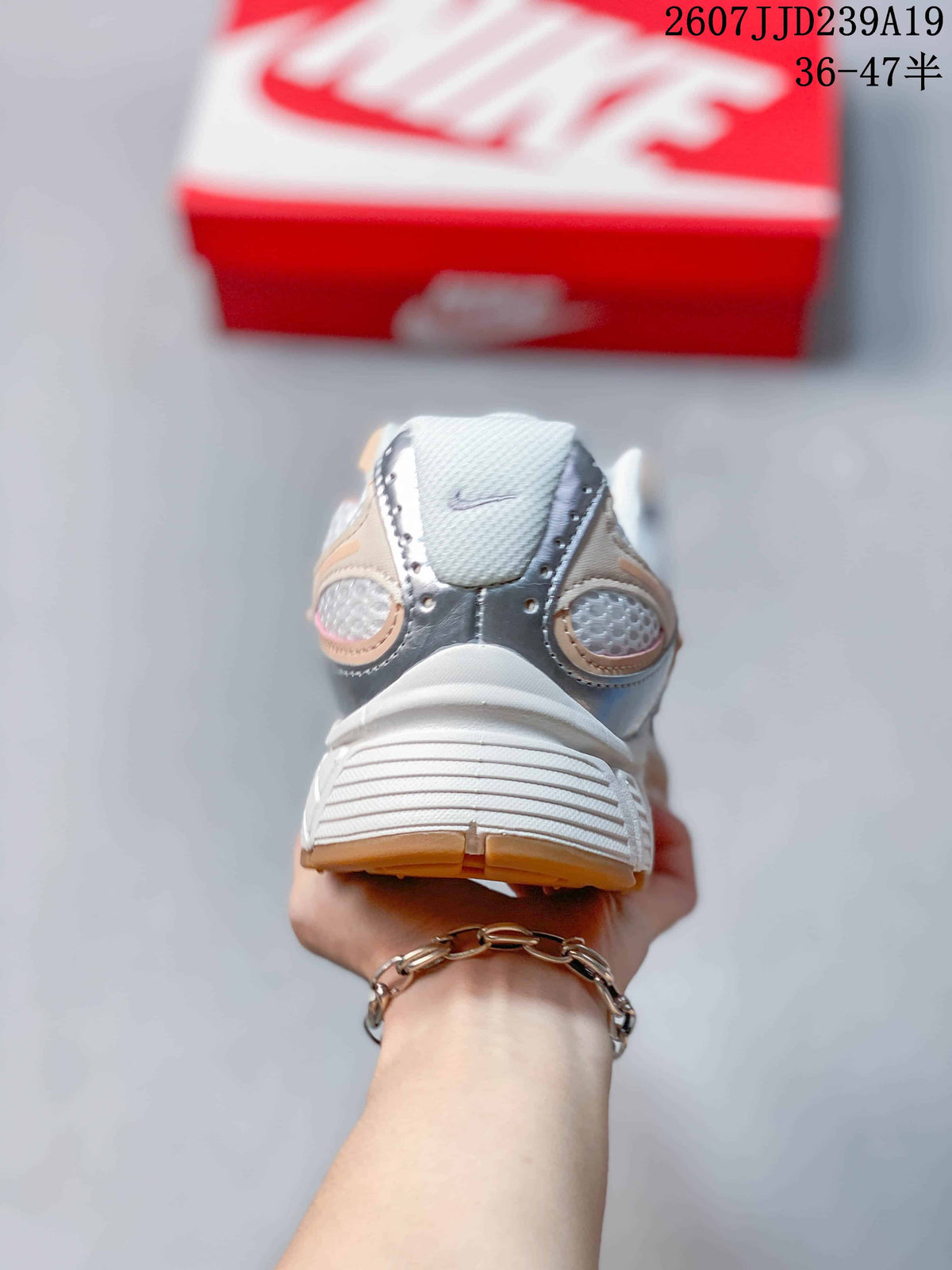 Rear view showing the padded heel, reflective-looking silver details, and gum-toned outsole sections.