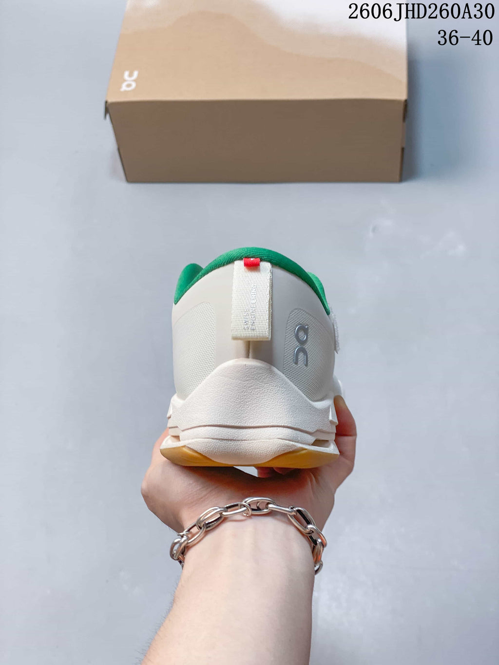 Rear view of the white sneaker with green collar lining