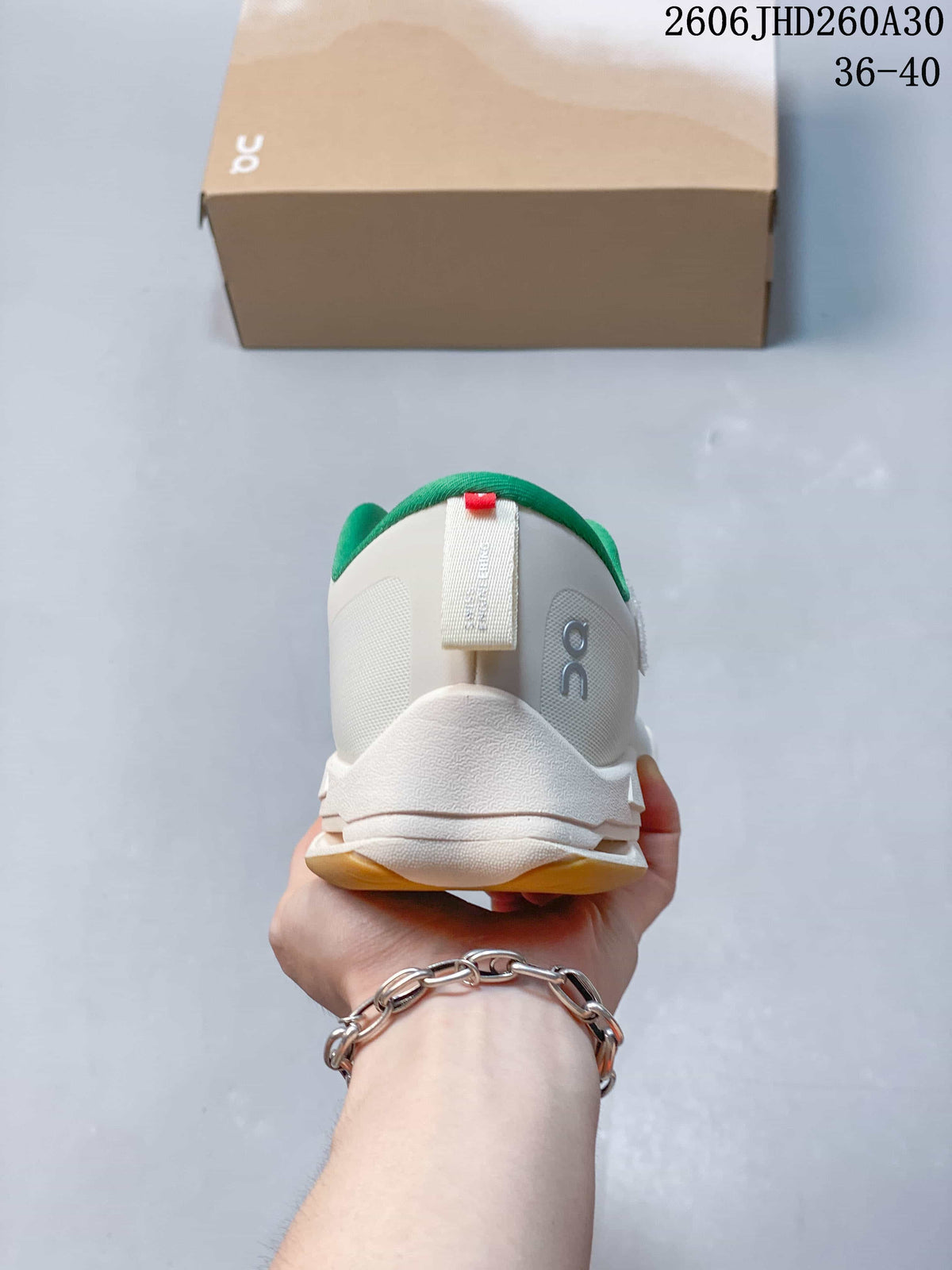 Rear view of the white sneaker with green collar lining