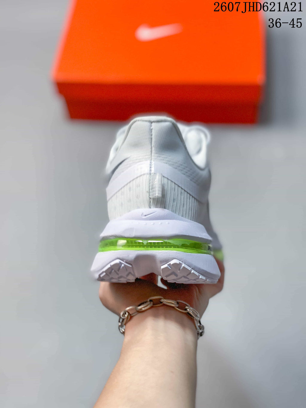Rear view of the sneaker showing the padded heel, white midsole, and translucent green cushioning unit.