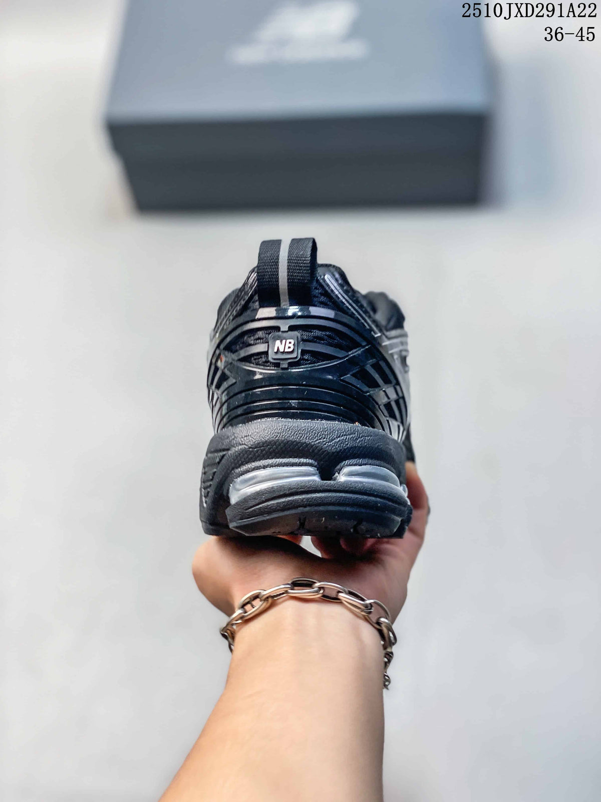Rear view showing the heel and outsole details of a New Balance M1906AD sneaker