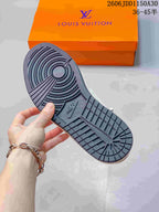 Underside of a sneaker showing a dark patterned outsole
