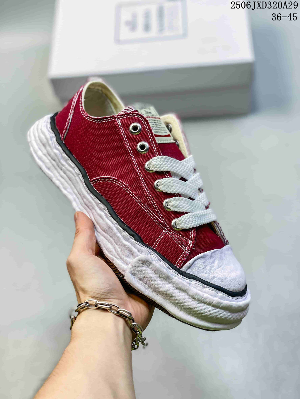 Angled side view of a red MMY sneaker with white laces, contrast stitching and a sculpted white sole; image text shows style code 2506JXD320A29 and size range 36–45.