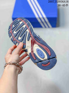 Close view of the patterned outsole showing blue, cream and burgundy sections and raised tread details.