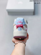 Rear view showing the white heel, blue heel tab and pink bow detail.