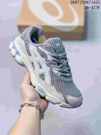 Gray and white ASICS GEL-Kayano 14 sneaker with blue accents.