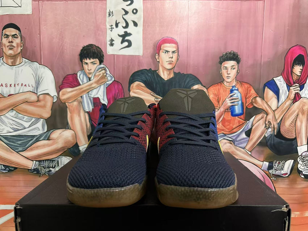 Front view of dark navy basketball shoes with red accents and translucent brown-toned outsoles.