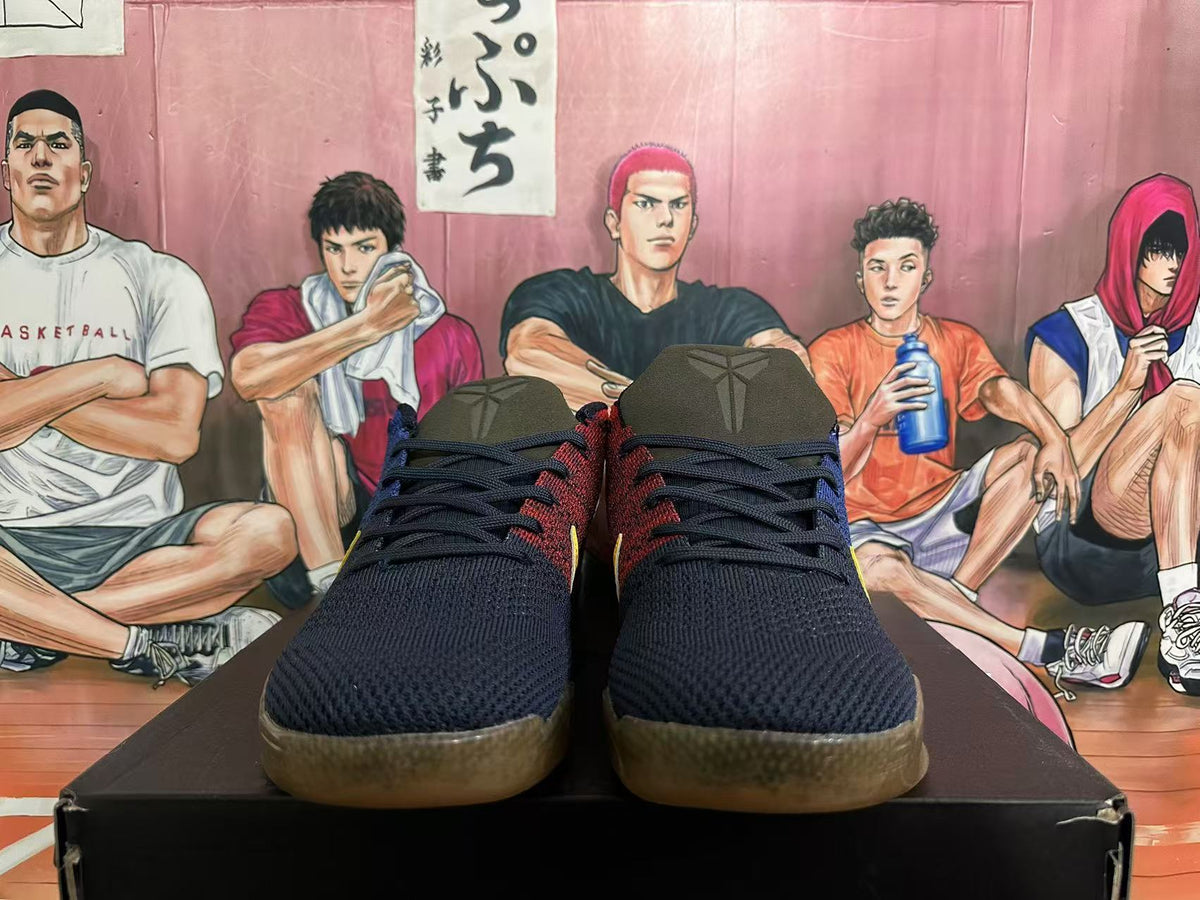 Front view of dark navy basketball shoes with red accents and translucent brown-toned outsoles.