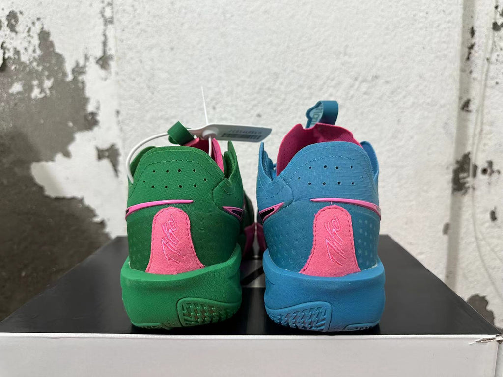 Rear view of mismatched Nike basketball shoes, one green and pink and one blue and pink