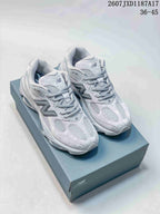 Pair of grey New Balance 9837 sneakers displayed on a branded shoe box.