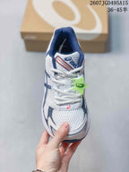Top view of the white and navy ASICS GEL-1130 sneaker with white laces, mesh-style toe panel and green hangtag.