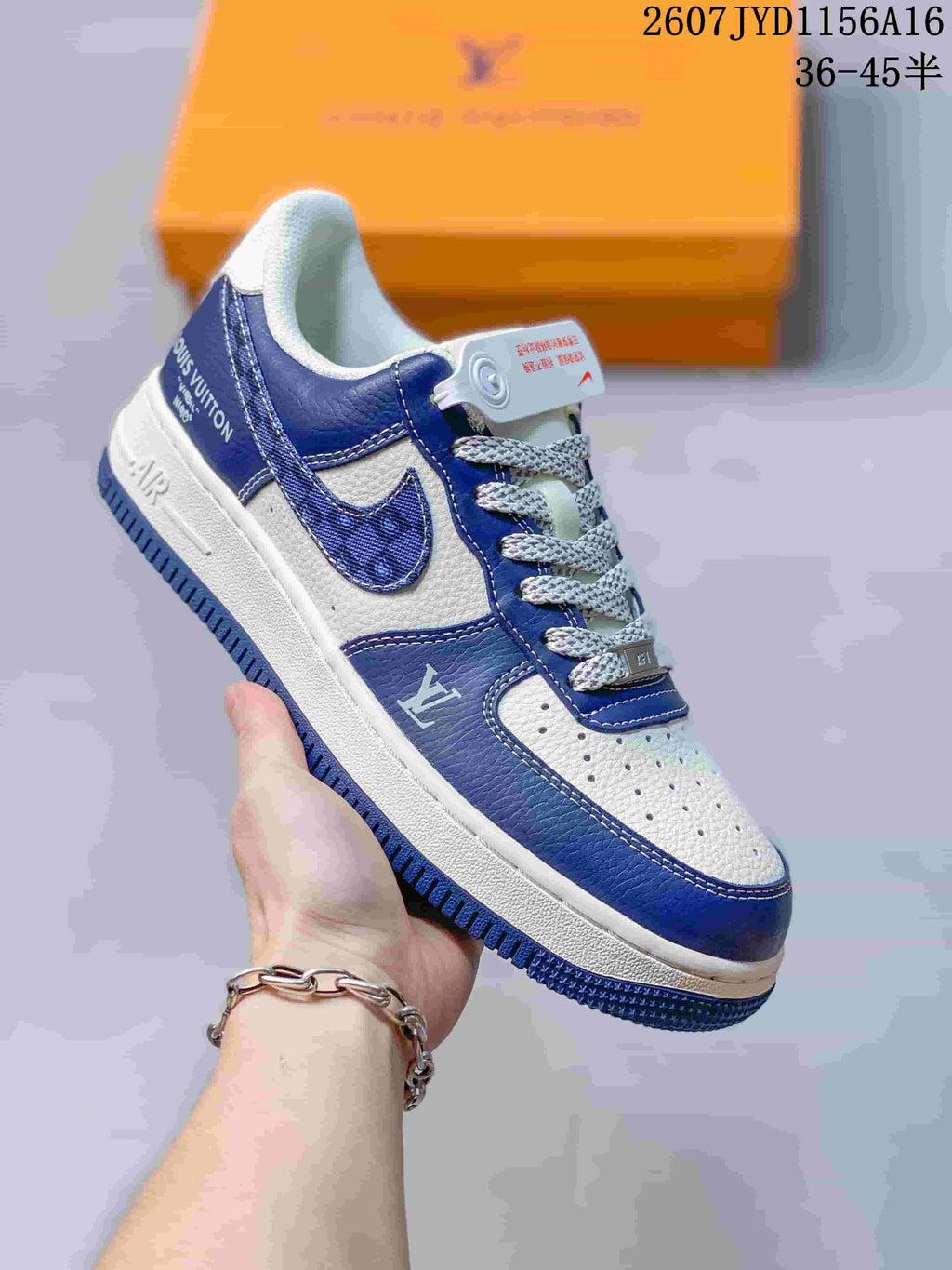 Close-up side view of a blue and white low-top sneaker showing the Swoosh, Louis Vuitton-style visible graphics, laces, and Air sole branding.