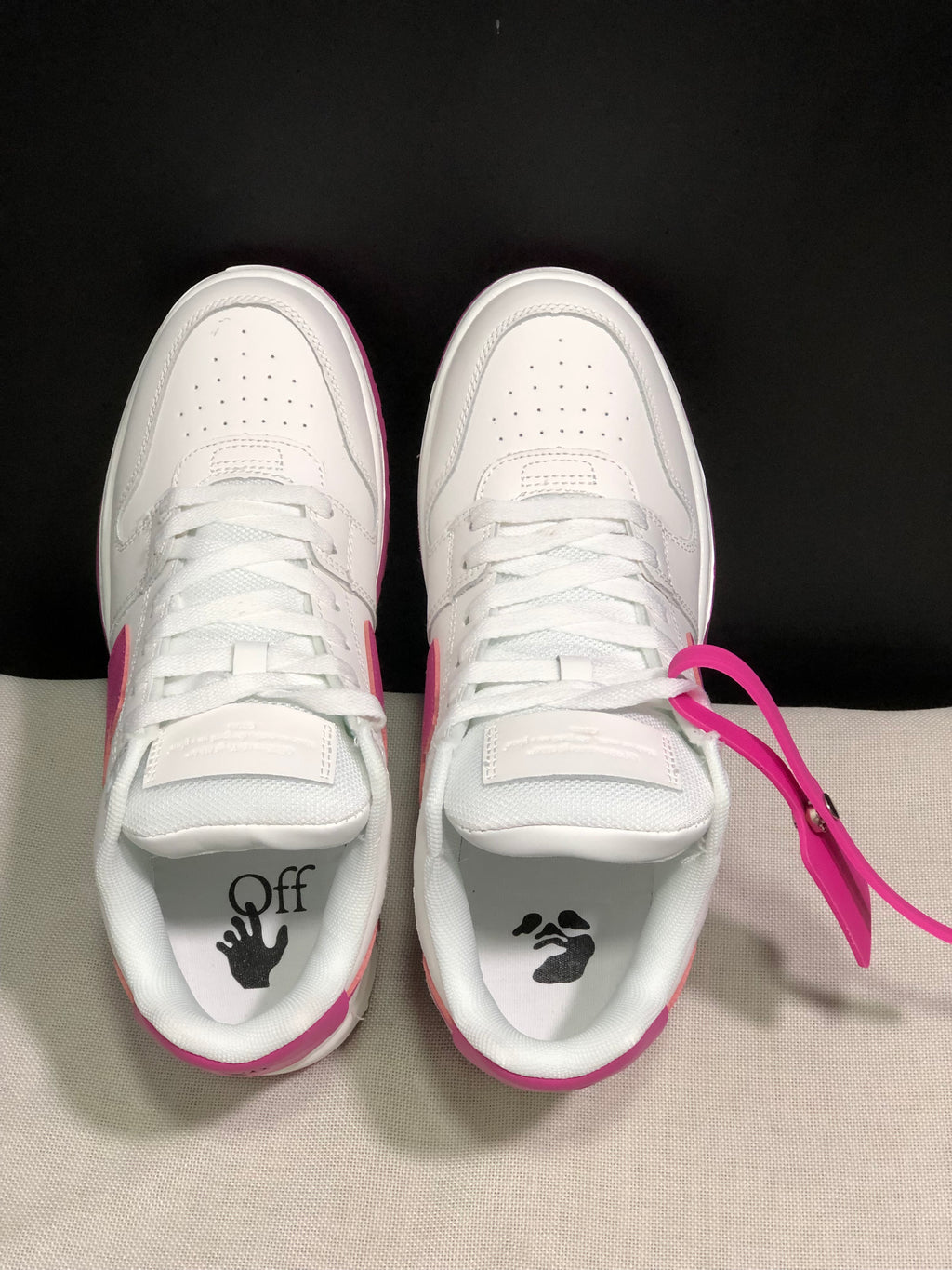 Top-down view showing white laces, perforated toe boxes, padded tongues and graphic sockliner details.