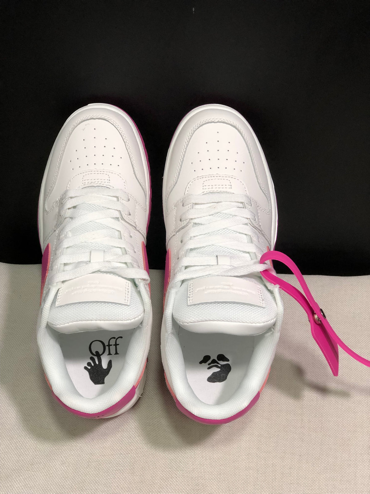 Top-down view showing white laces, perforated toe boxes, padded tongues and graphic sockliner details.