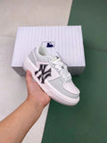 Light gray MLB low-top sneaker with a contrasting New York side logo, shown in front of a matching shoe box.