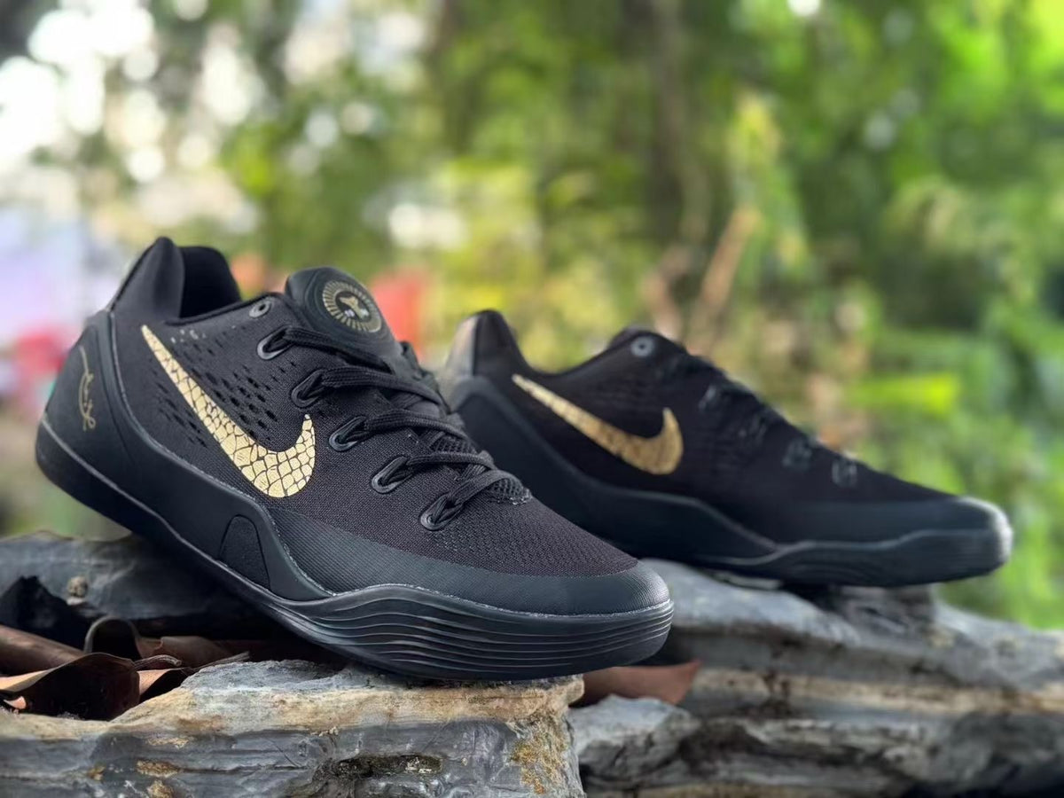 Angled view of black Kobe 9 shoes with gold-toned details.
