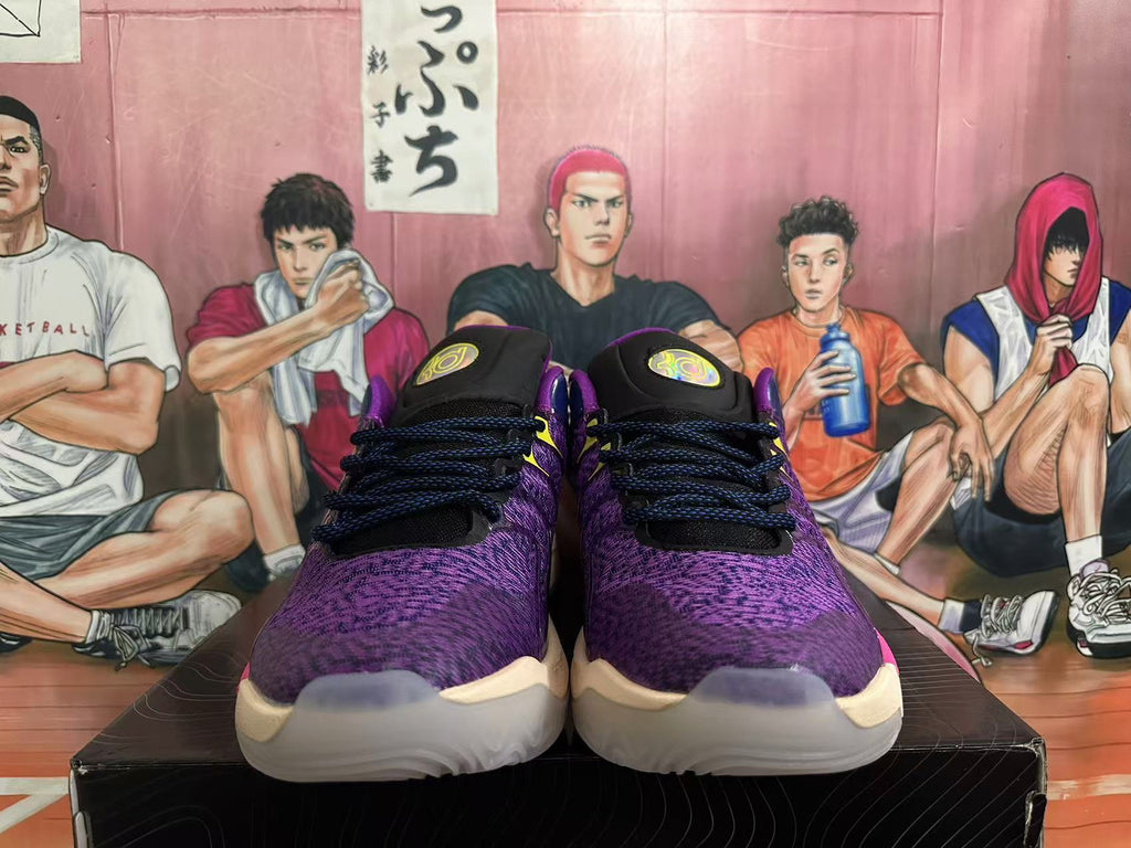 Front view of purple patterned Nike basketball shoes with dark laces and yellow tongue details.