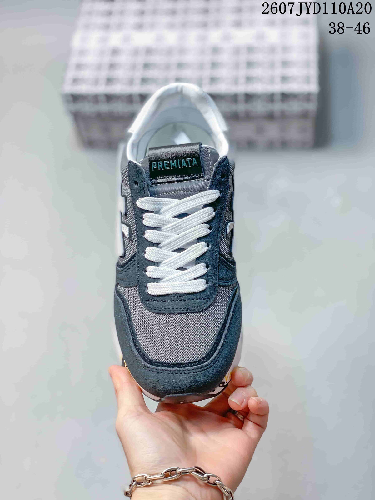 Top view of the sneaker showing the gray mesh toe area, navy overlays, and white laces.