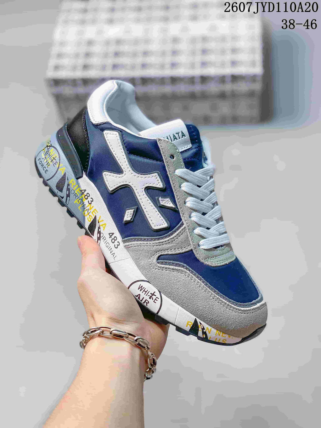 Navy and white Premiata sneaker with gray suede-look overlays and printed midsole.