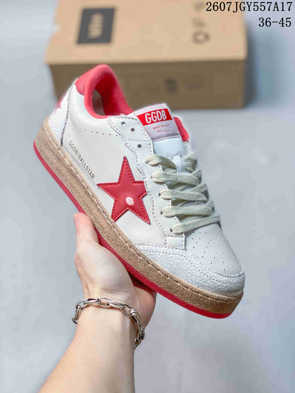 Three-quarter side view showing the white upper, red star detail, cream laces, textured toe panel and Ball Star side branding.