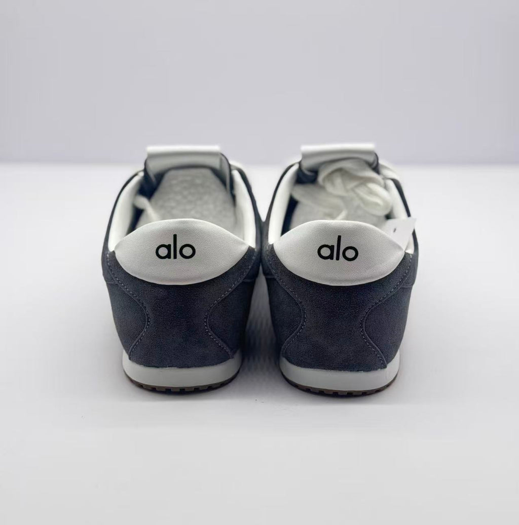 Rear view of the pair with Alo branding on the white heel accents.