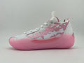 Side view of a white and pink low-top sneaker with a patterned upper and pink sole