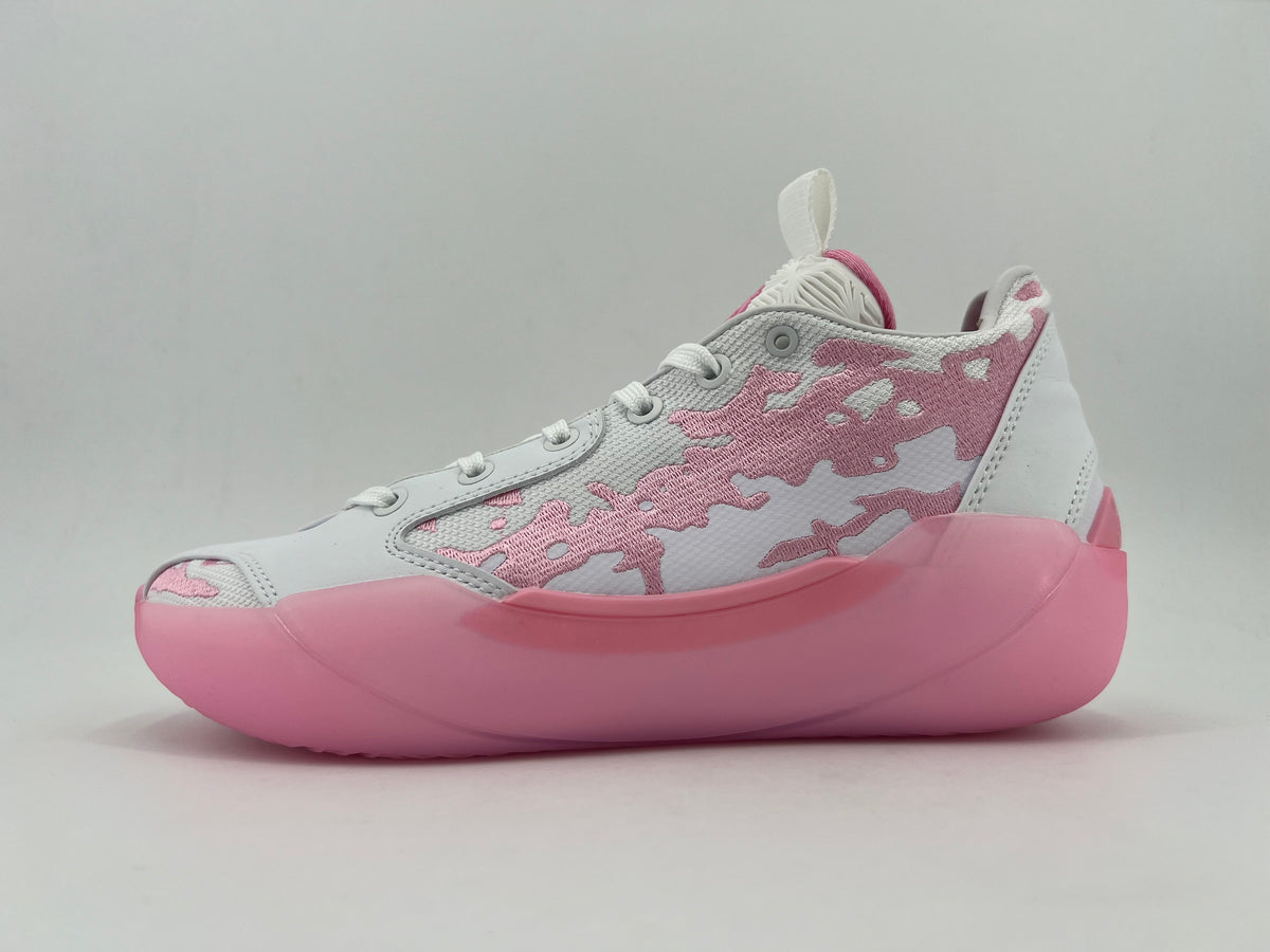 Side view of a white and pink low-top sneaker with a patterned upper and pink sole