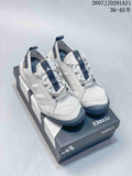 Pair of white and navy adidas Terrex hiking shoes displayed on a branded shoebox.